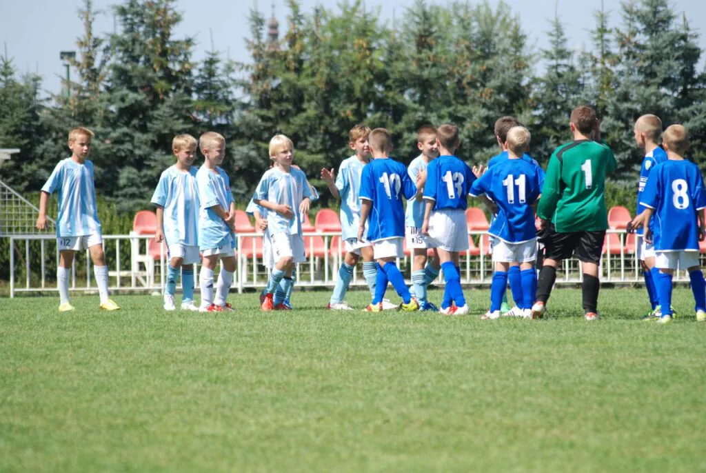Two youth soccer teams lined up on the field before a match